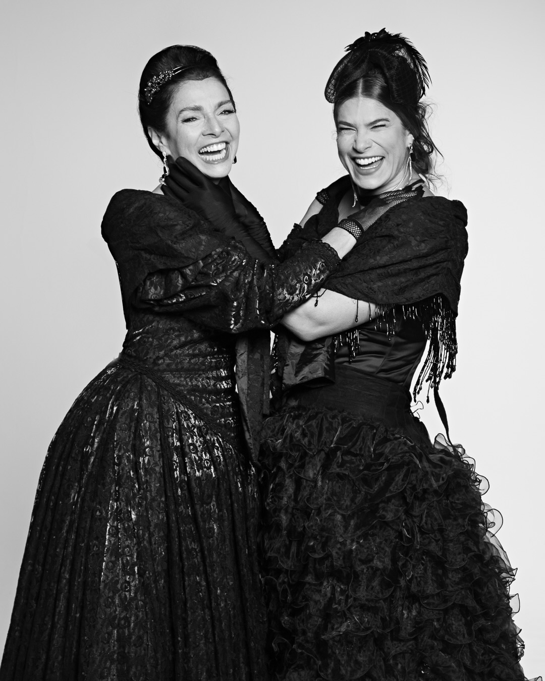 Claudia Ohana e Priscila Fantin abraçadas e sorrindo, em As Amantes de George Washington